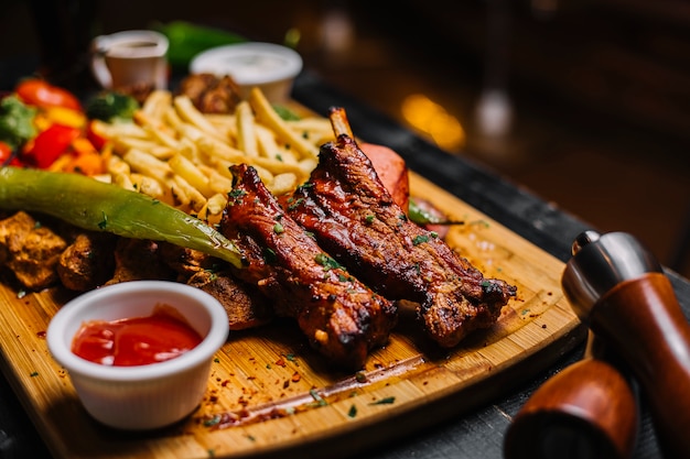 Side view fried meat with french fries and ketchup