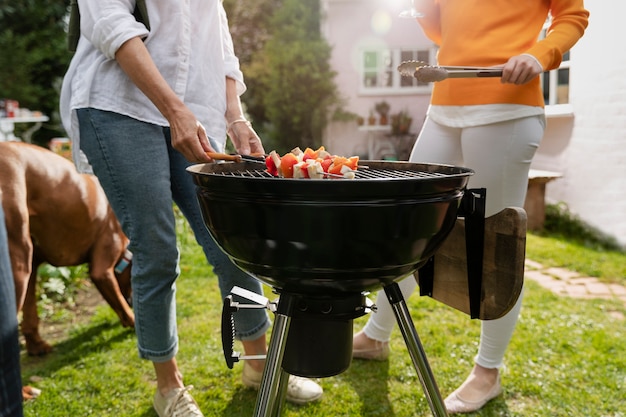 Side view friends making barbecue