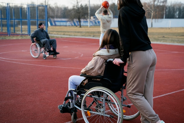 Side view friends playing basketball together