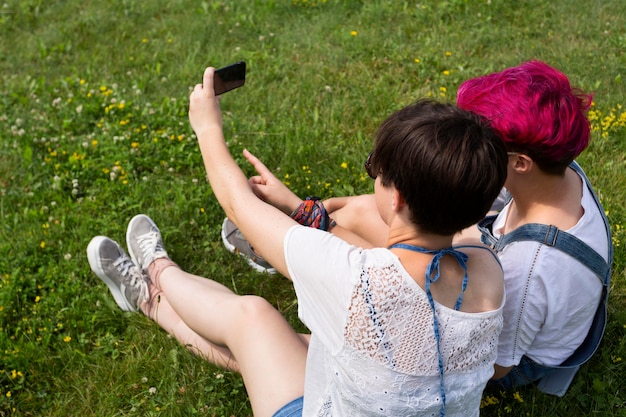 Side view friends taking selfie