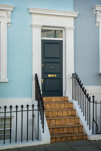 Free Photo side view of front door with blue wall