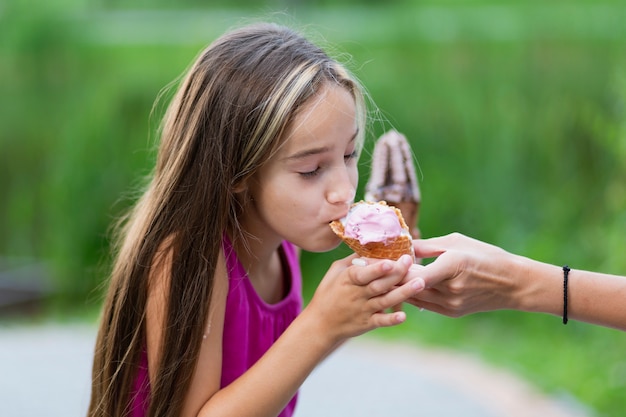 Free photo side view of girl eating ice cream