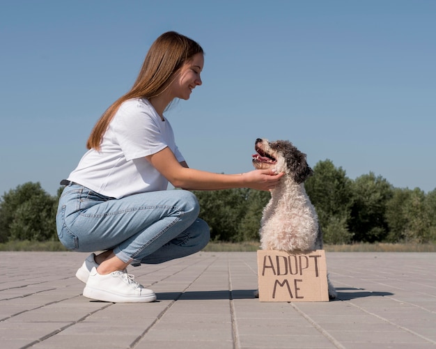 Free Photo side view girl petting cute dog