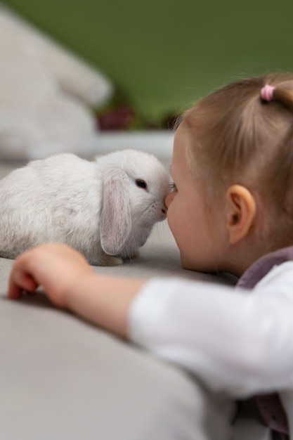 Side view girl playing with bunny