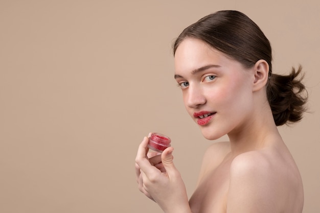 Side view girl posing with lip scrub