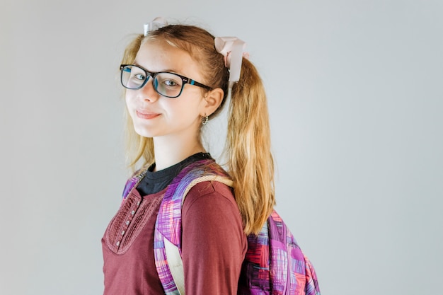 Side view of a girl with backpack