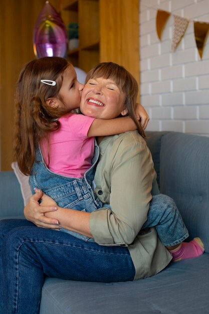 Side view girl with granny at home