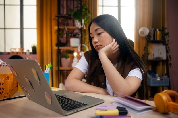 Side view girl with laptop at home