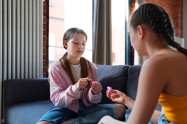 Free photo side view girls holding menstrual cups