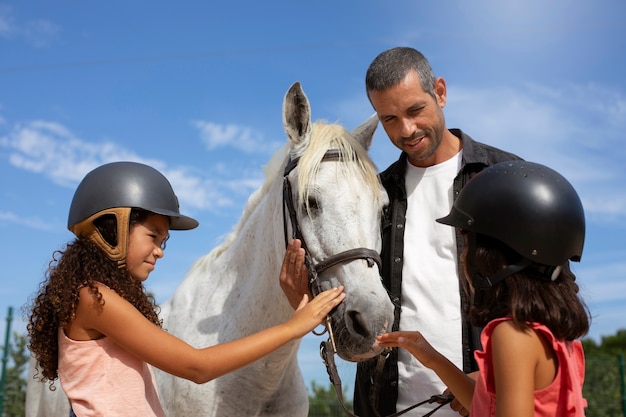 Side view girls with beautiful horse