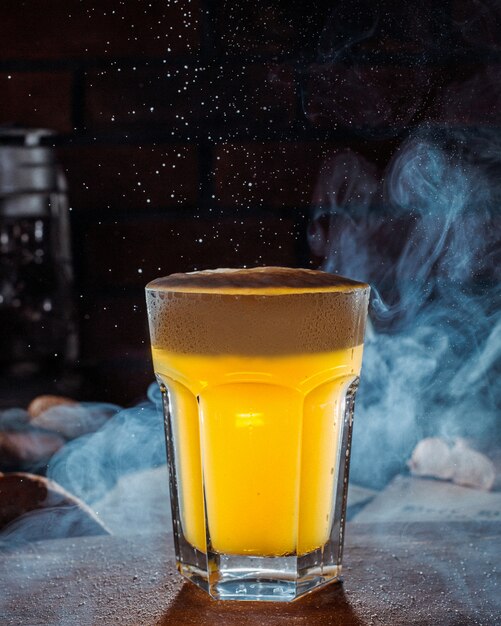 Side view of glass of light beer on a table