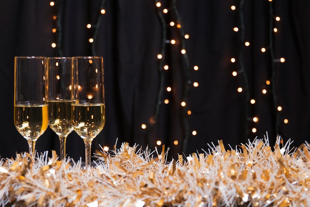 Free Photo side view glasses with champagne for new year