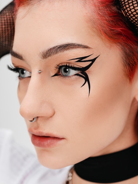 Side view goth teenager posing in studio