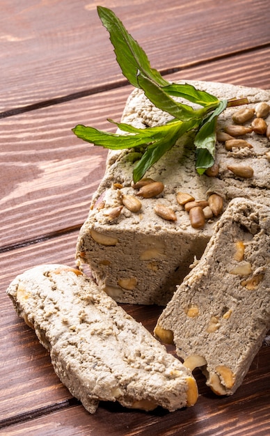 Side view halva of seeds with seeds with herbs on the table