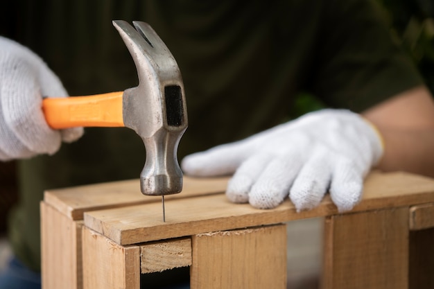 Side view hand holding hammer