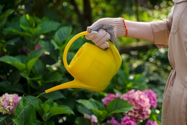 Side view hand holding watering can