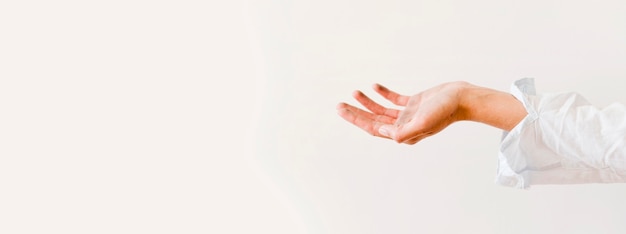 Side view of hands asking for food donation with copy space