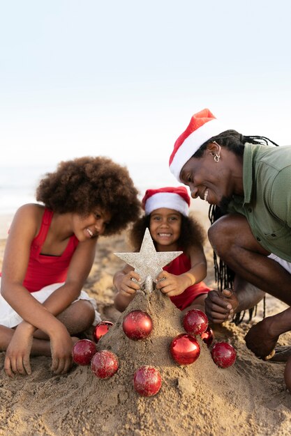 Side view happy family at beach with globes