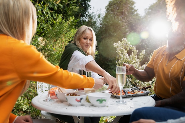 Side view happy friends partying outdoors