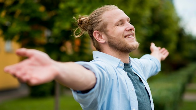 Free photo side view of happy man outdoors