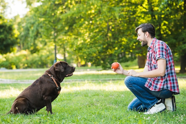 Side view of a happy man playing with his dog