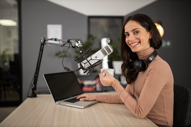 Side view of happy woman doing radio