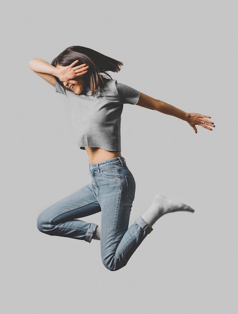 Free Photo side view of happy woman jumping in the air