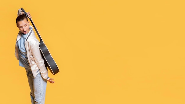 Side view of happy woman with guitar