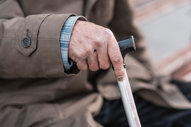 Side view of homeless man with cane