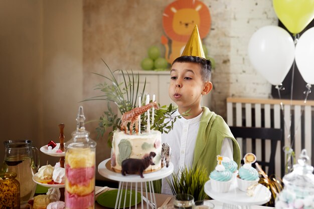 Side view kid blowing candles