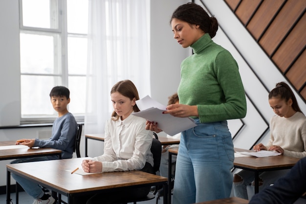 Free Photo side view kid cheating at school test