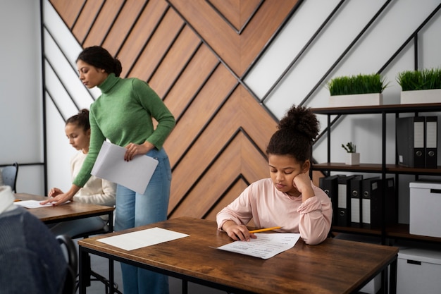 Side view kid cheating at school test