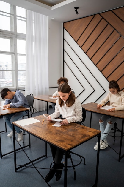 Side view kid cheating at school test