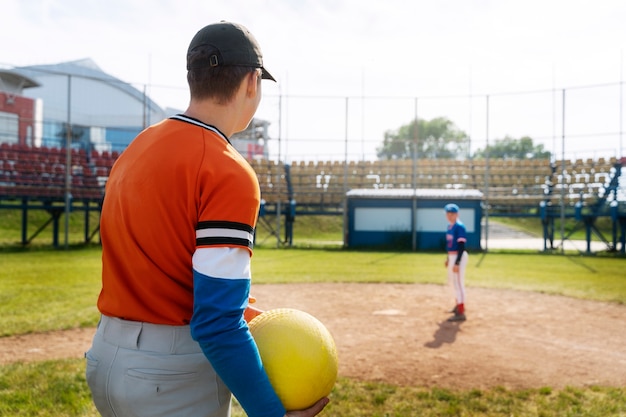 Side view kid holding ball