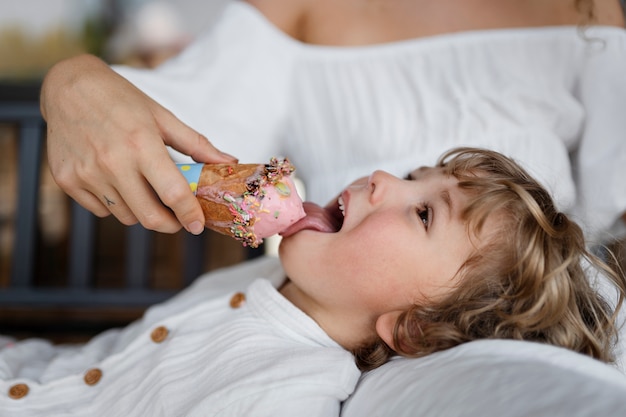 Free photo side view kid licking ice cream cone