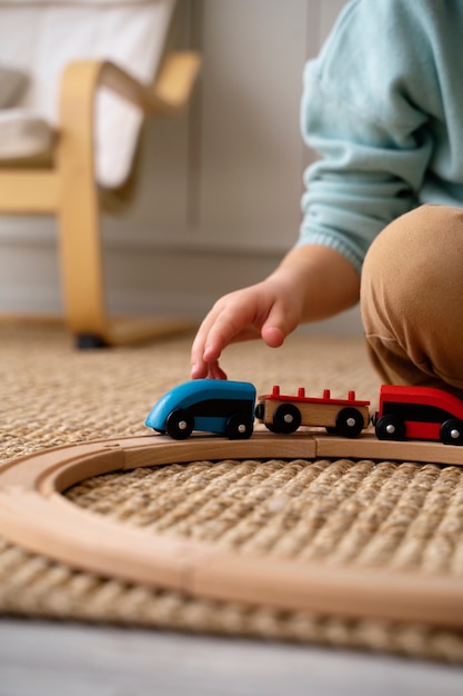 Free photo side view kid playing with train