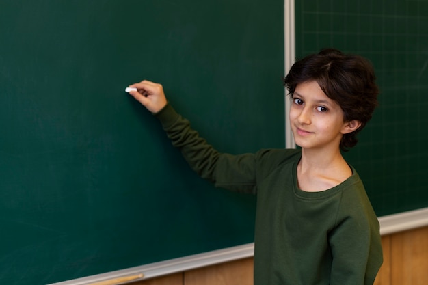 Side view kid writing on board