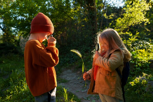 Side view kids exploring nature together