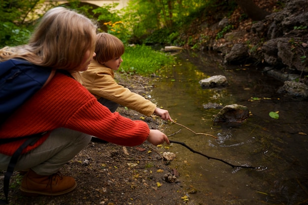 Side view kids exploring nature together