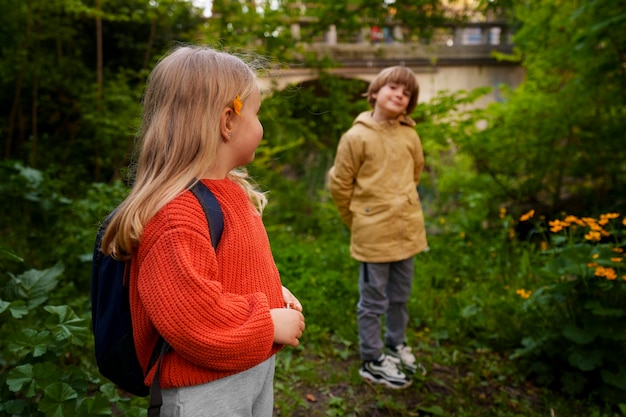 Side view kids exploring nature together