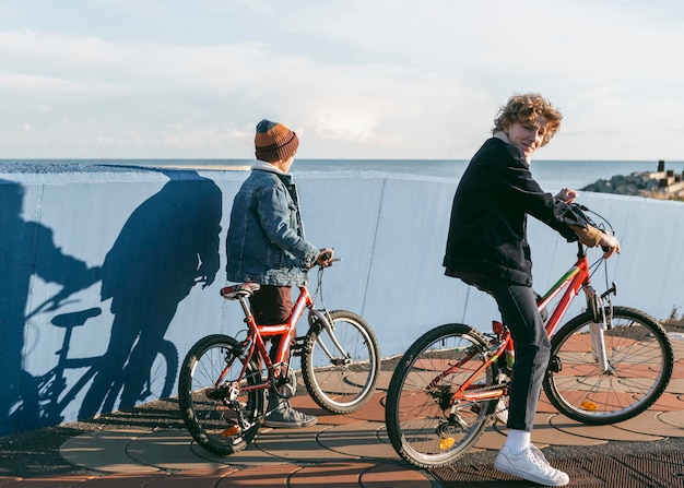 Side view of kids riding bicycles outdoors