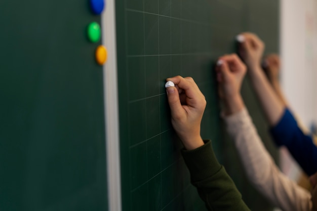 Side view kids writing on board