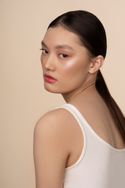 Free photo side view korean woman posing in studio