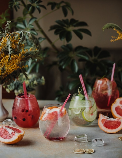 Side view of lemonade with grapefruit and lme in drinking glasses on the tablepg