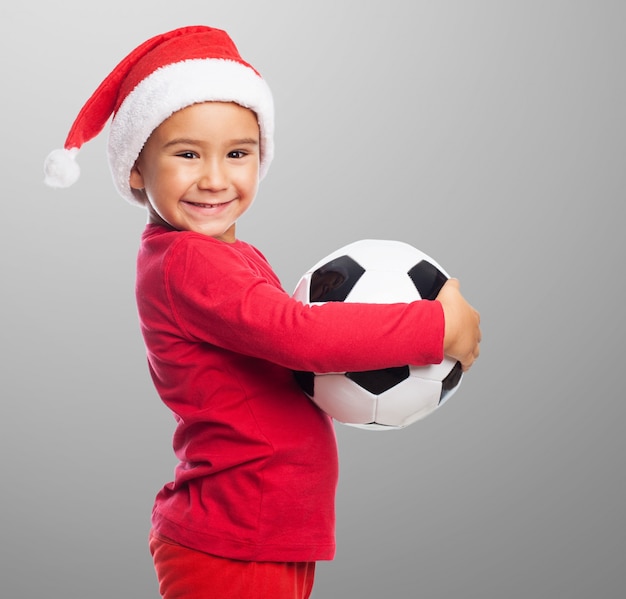 Side view of little boy with his ball