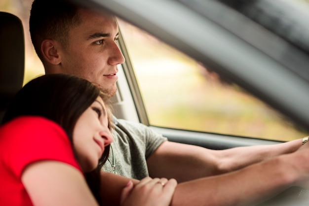 Side view of lovely couple in car