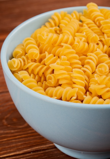 Side view of mafalda pasta in bowl on wooden table