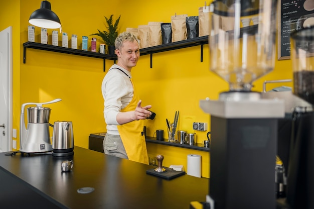 Side view of male barista in shop