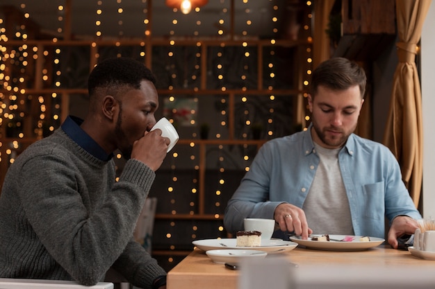 Side view male friends at restaurant