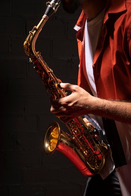 Side view of male musician playing saxophone